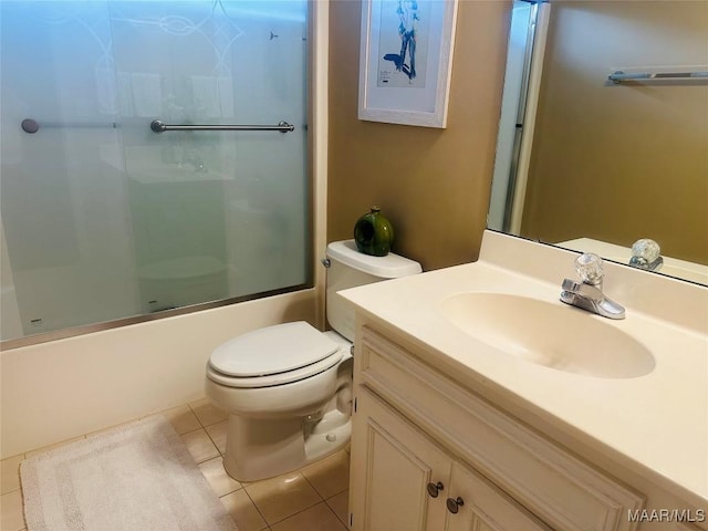 full bathroom featuring vanity, combined bath / shower with glass door, tile patterned floors, and toilet