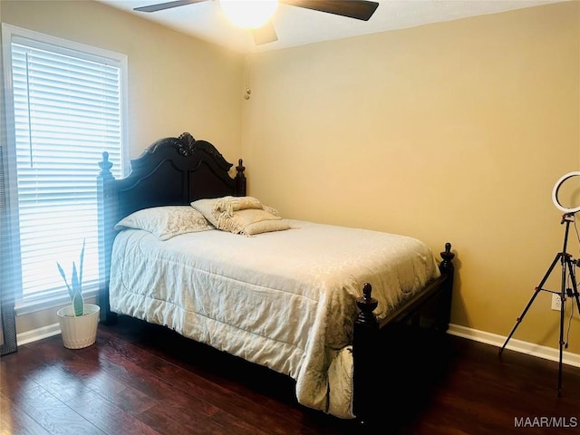 bedroom featuring ceiling fan and dark hardwood / wood-style flooring