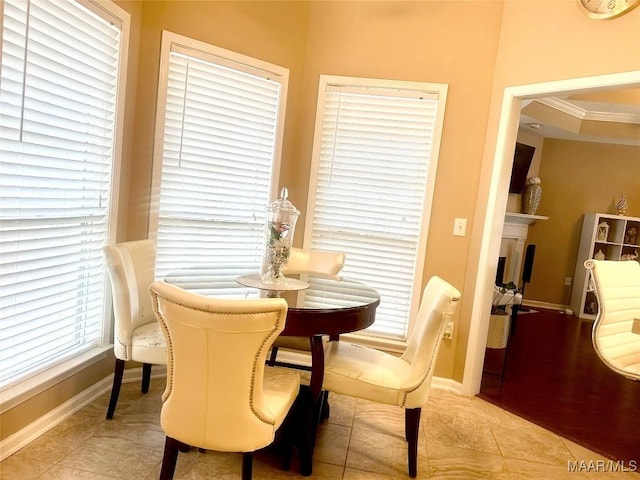 dining room with light tile patterned floors and ornamental molding