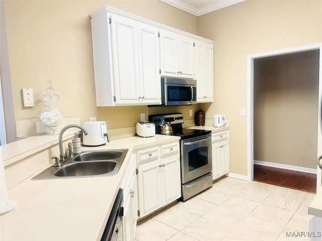 kitchen featuring stainless steel appliances, crown molding, sink, and white cabinets