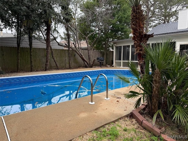 view of swimming pool with a fenced in pool, a sunroom, a grill, and fence