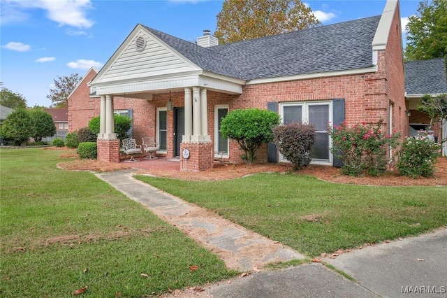 view of front of house with a front yard and covered porch