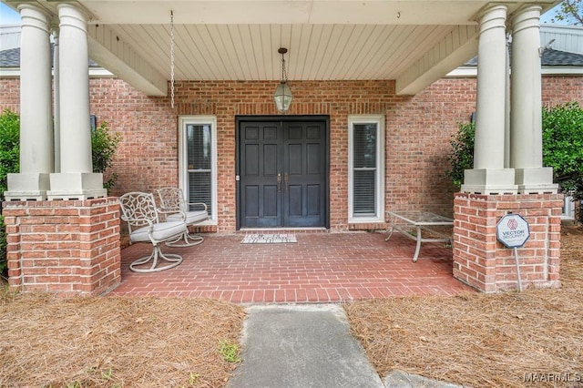 doorway to property featuring covered porch