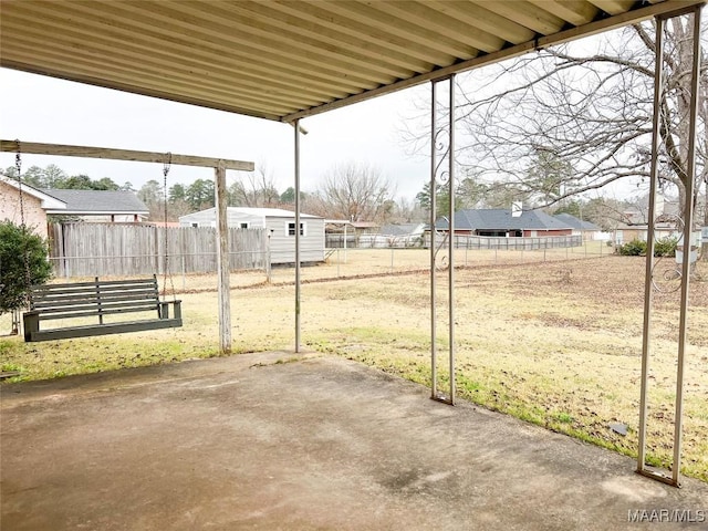 view of yard with a storage shed and a patio area