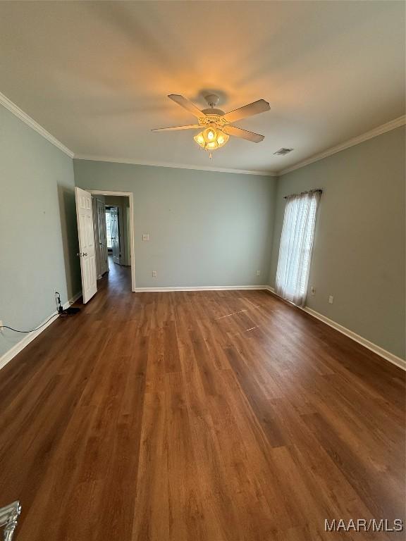 interior space featuring ornamental molding, dark wood-type flooring, and ceiling fan