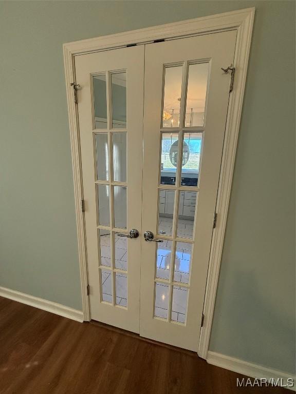 doorway with dark hardwood / wood-style flooring and french doors