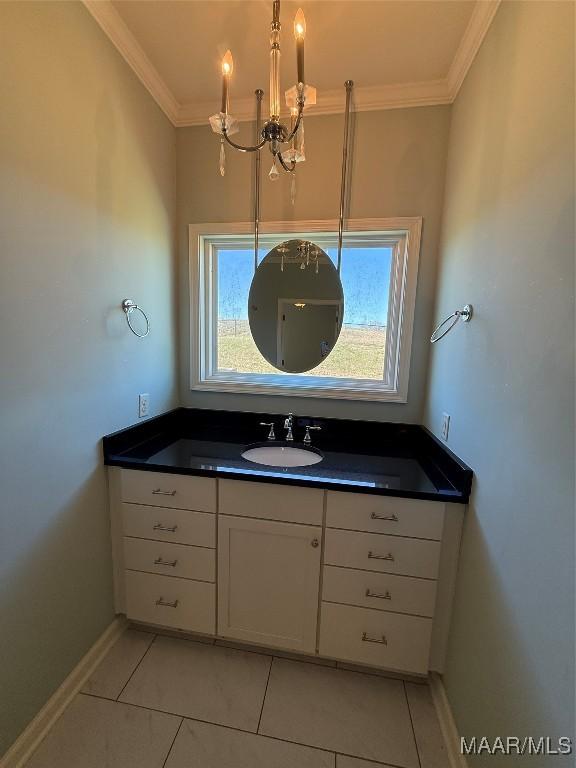 bathroom featuring crown molding, a healthy amount of sunlight, vanity, and tile patterned floors