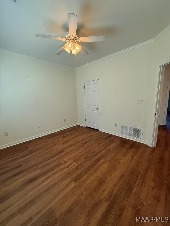 spare room featuring ornamental molding, dark hardwood / wood-style floors, and ceiling fan