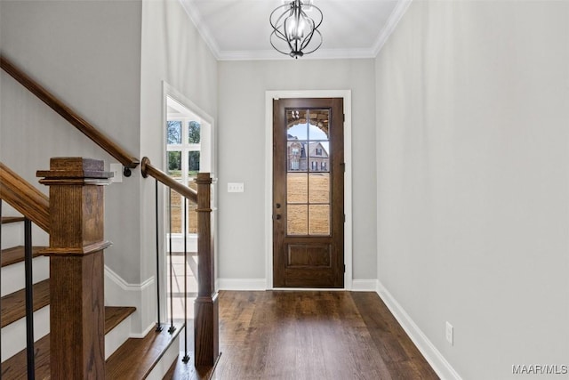 foyer featuring dark hardwood / wood-style flooring, a notable chandelier, and crown molding