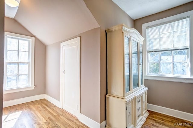 additional living space with lofted ceiling and light wood-type flooring