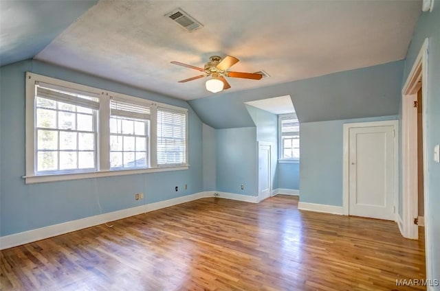 bonus room featuring ceiling fan, lofted ceiling, and light wood-type flooring