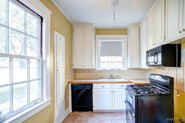 kitchen with sink, tasteful backsplash, black appliances, white cabinets, and light tile patterned flooring