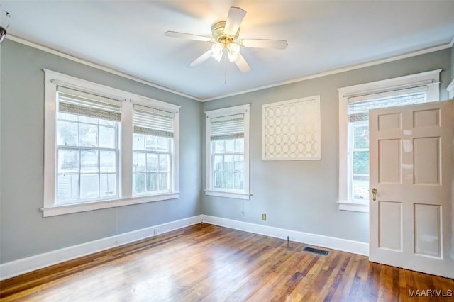 spare room with crown molding, wood-type flooring, and ceiling fan