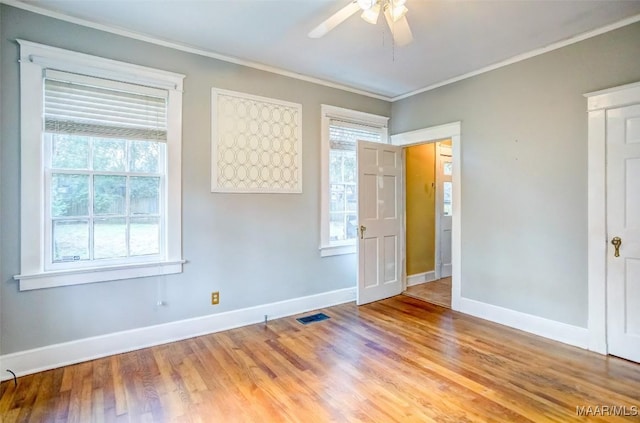 spare room featuring crown molding, ceiling fan, and light hardwood / wood-style flooring