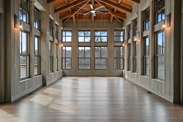 unfurnished sunroom with wood ceiling and lofted ceiling with beams