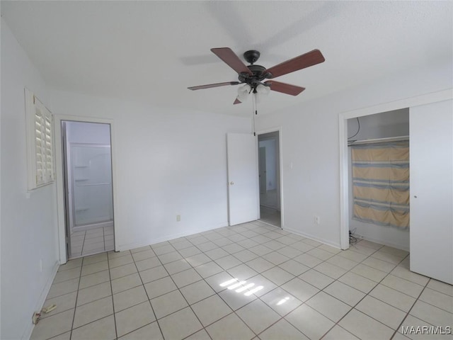 unfurnished bedroom featuring a closet, ceiling fan, and light tile patterned flooring