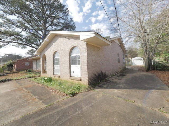 view of property exterior featuring a garage and an outdoor structure