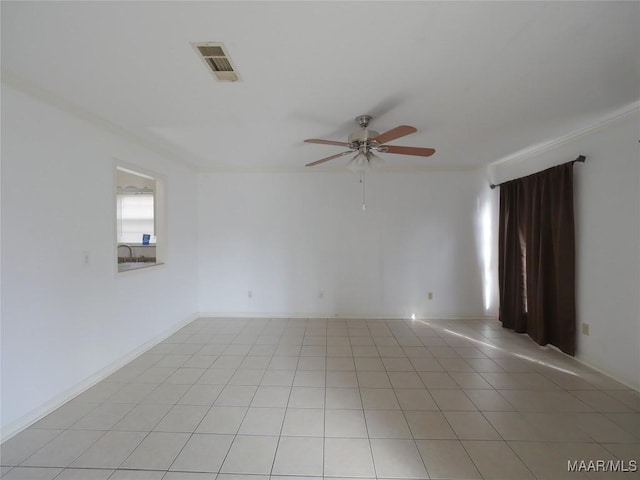 tiled spare room with ceiling fan