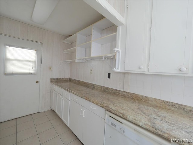 kitchen featuring light tile patterned floors, dishwasher, and white cabinets