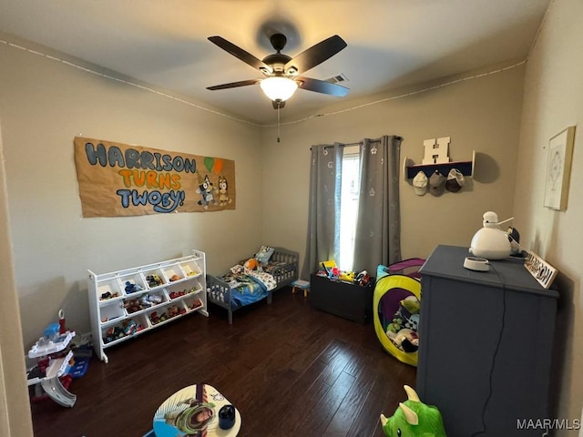 playroom with dark hardwood / wood-style flooring and ceiling fan