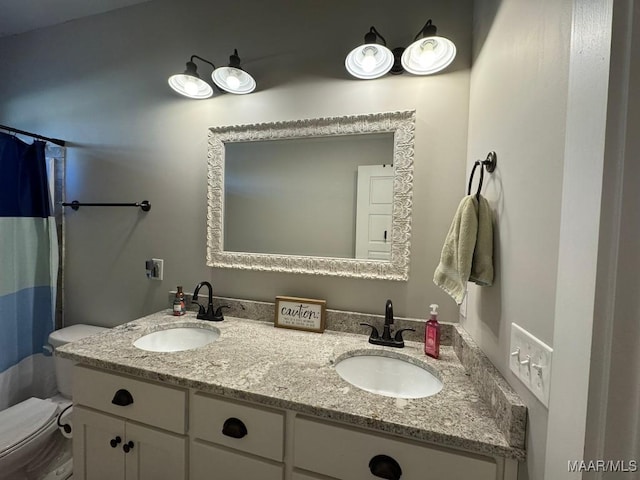 bathroom featuring vanity and toilet