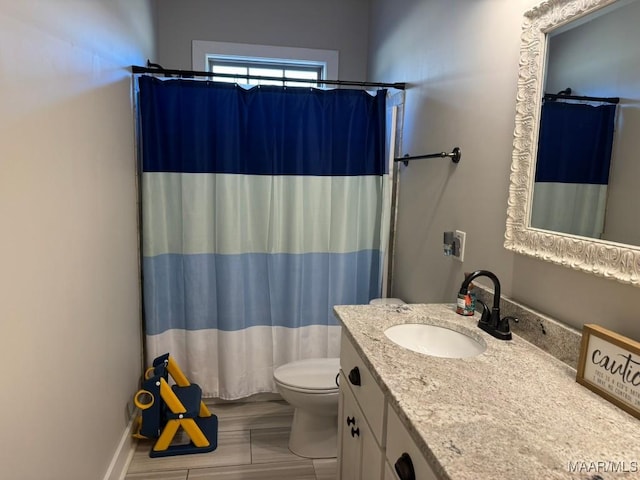 bathroom with vanity, toilet, and a shower with shower curtain