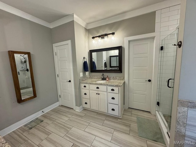 bathroom with vanity, ornamental molding, and walk in shower