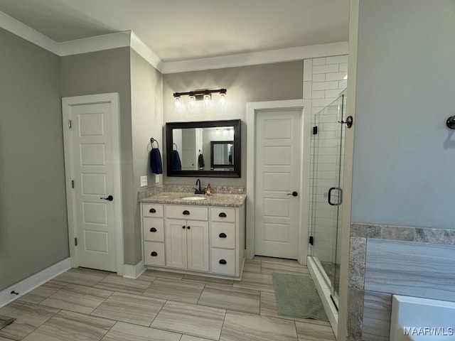 bathroom featuring crown molding, vanity, and a shower with shower door