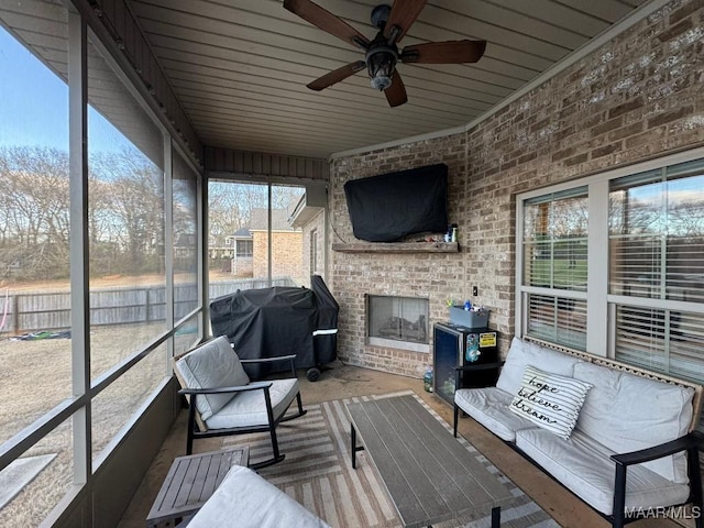 sunroom featuring ceiling fan