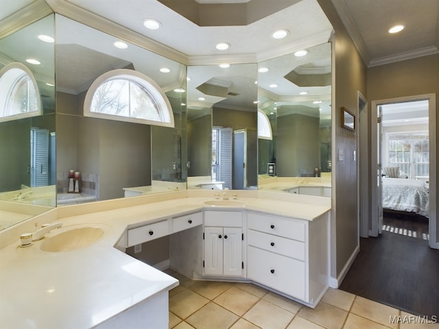 bathroom with vanity, tile patterned flooring, and crown molding