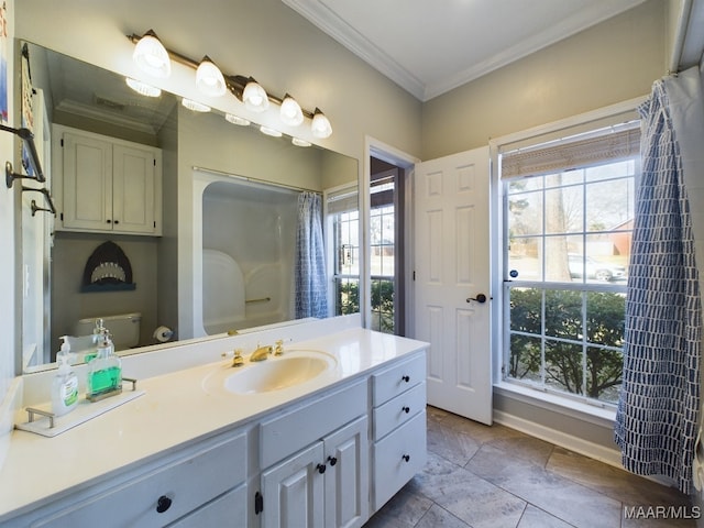 bathroom with crown molding, plenty of natural light, vanity, and toilet