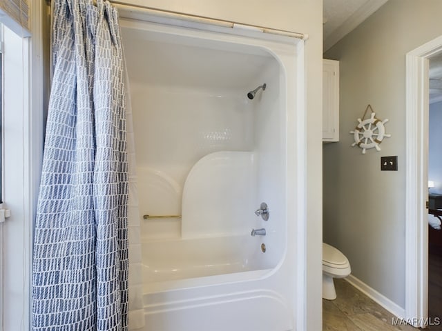 bathroom featuring shower / bathtub combination with curtain, tile patterned flooring, and toilet