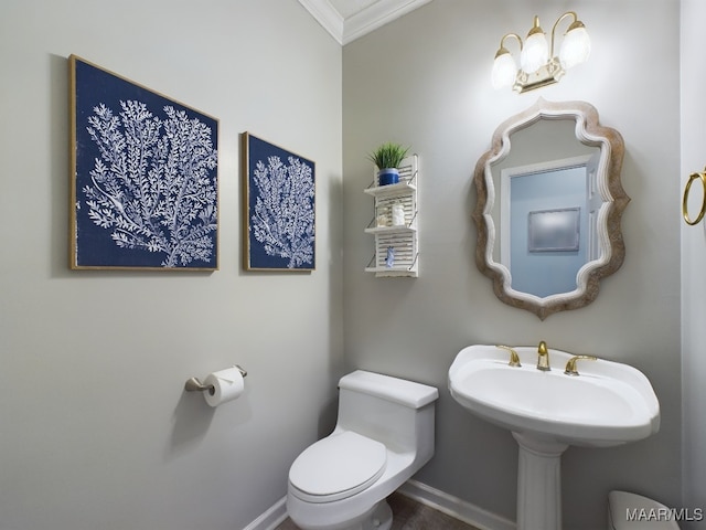 bathroom with ornamental molding and toilet