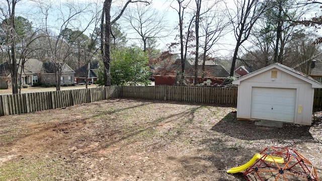 view of yard featuring a garage and an outdoor structure