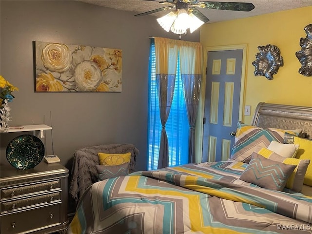 bedroom with a textured ceiling and ceiling fan