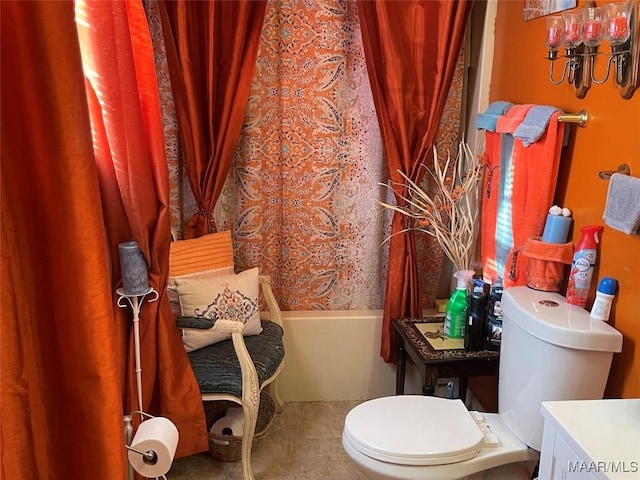 bathroom with toilet and shower / bath combo with shower curtain