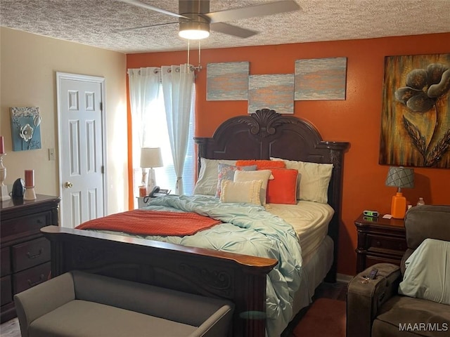 bedroom with ceiling fan and a textured ceiling