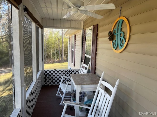 sunroom / solarium featuring ceiling fan