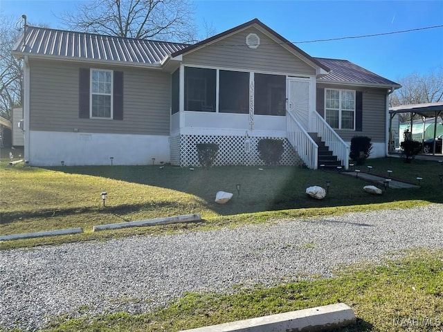 view of front of home featuring a front yard and a sunroom