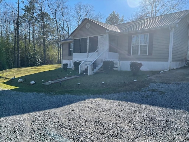 view of front of property featuring a sunroom and a front yard