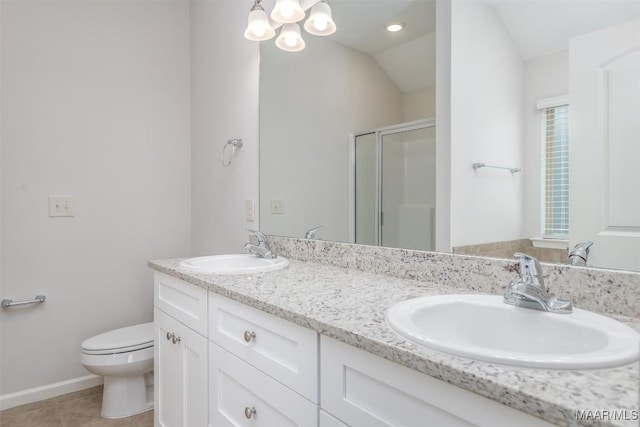 bathroom featuring a shower with door, vanity, tile patterned floors, and toilet