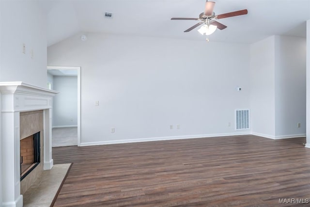 unfurnished living room with ceiling fan, a high end fireplace, dark hardwood / wood-style floors, and vaulted ceiling