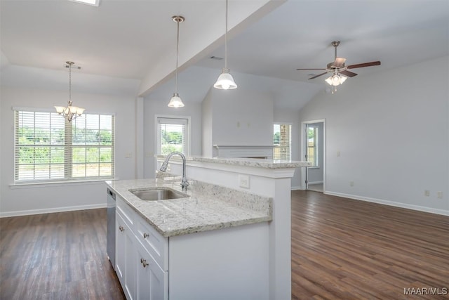 kitchen featuring hanging light fixtures, sink, a center island with sink, and white cabinets