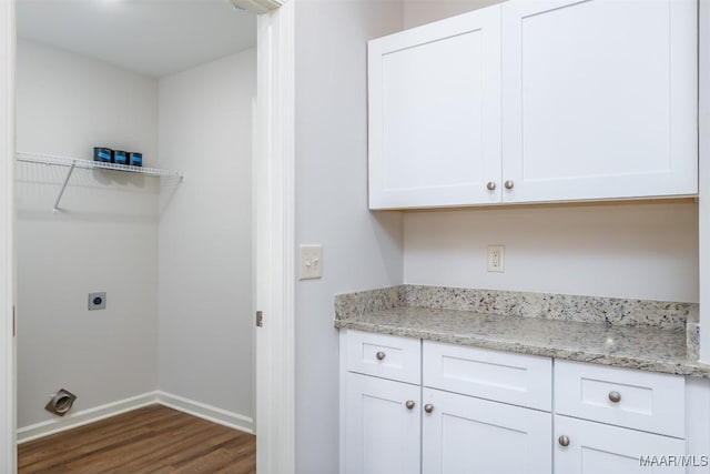 laundry area with cabinets, electric dryer hookup, and dark hardwood / wood-style flooring