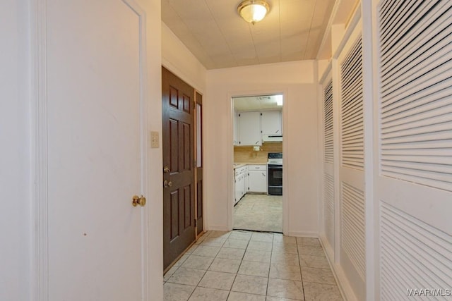 hallway featuring light tile patterned floors