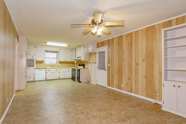 kitchen featuring white cabinetry, electric range oven, wood walls, and dishwasher