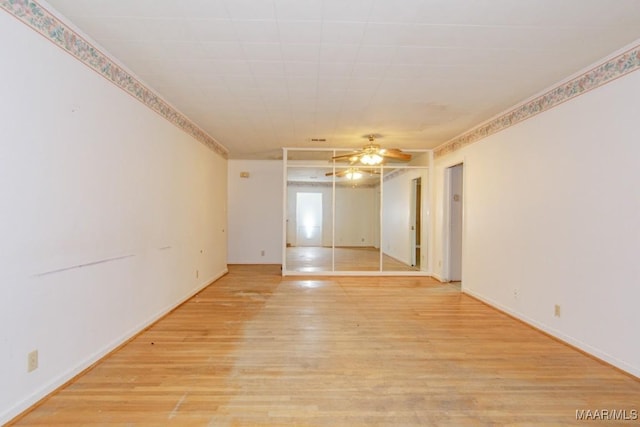 empty room with light wood-type flooring and ceiling fan