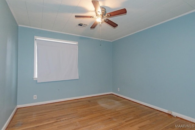 empty room with ceiling fan, crown molding, and light hardwood / wood-style floors