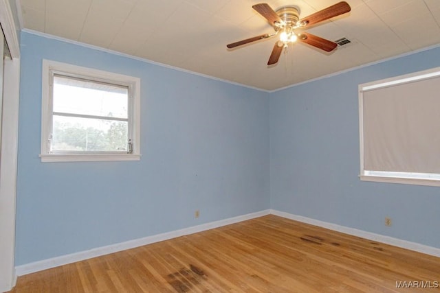 spare room with light hardwood / wood-style floors, crown molding, and ceiling fan