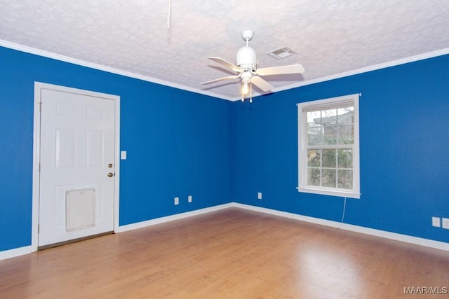 spare room featuring wood-type flooring, ceiling fan, crown molding, and a textured ceiling